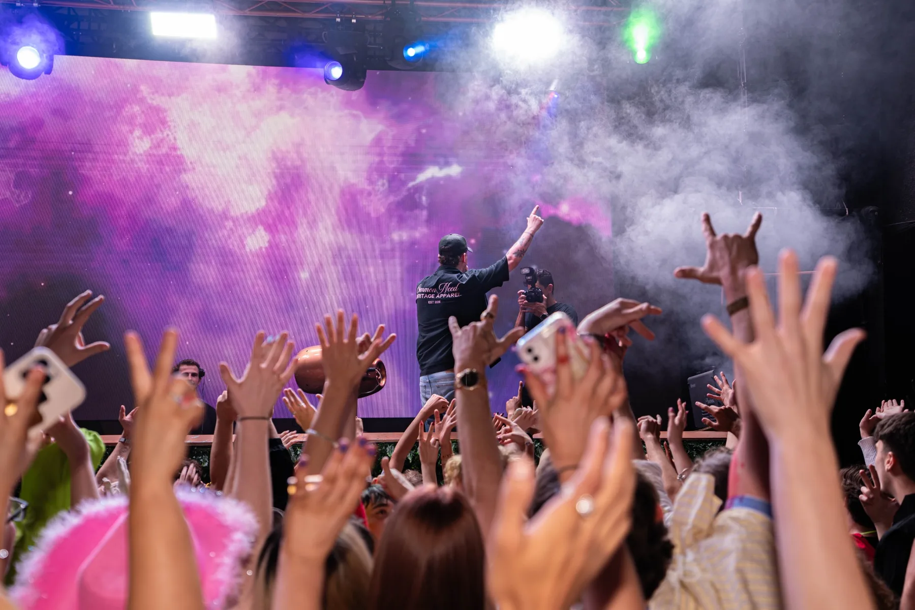 Crowd reaching toward a live performer during an event