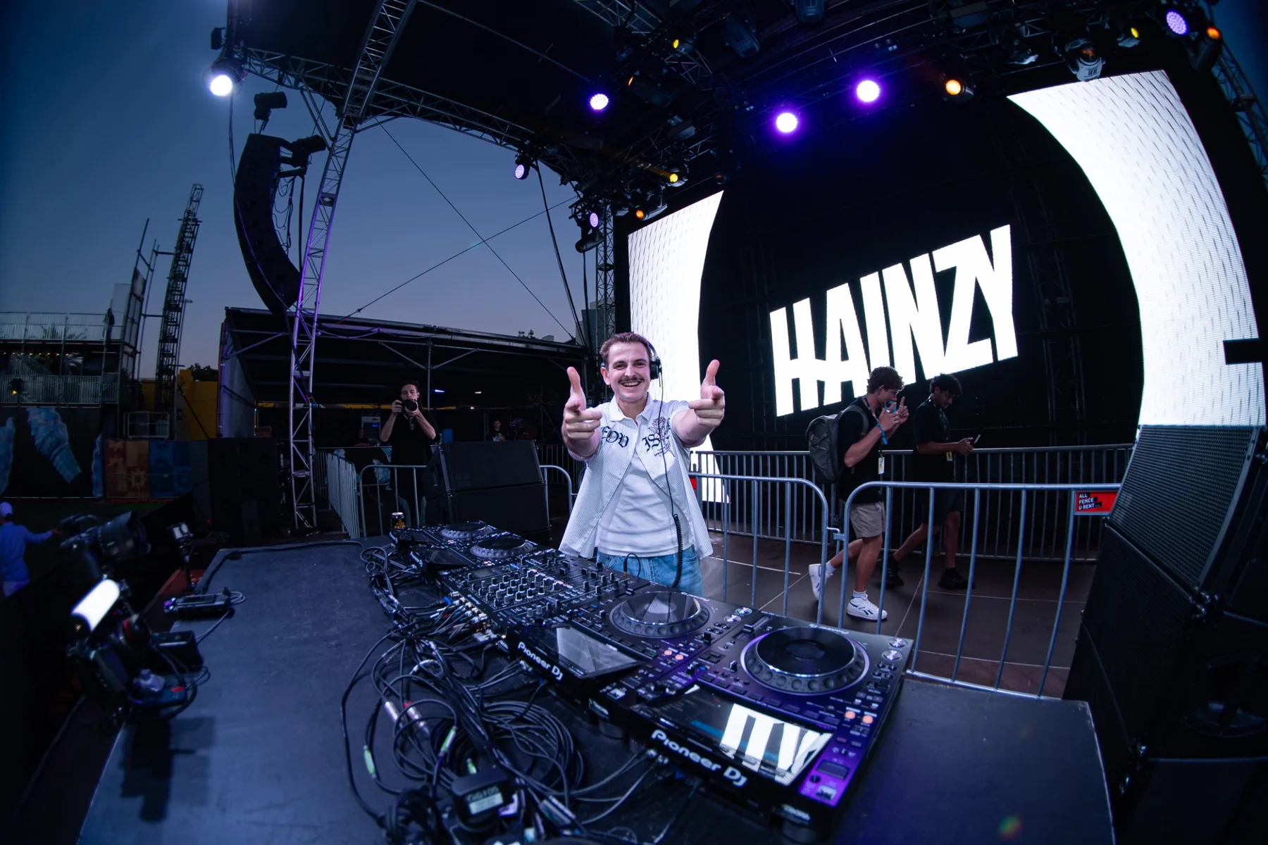 DJ on a festival stage in front of a large LED screen